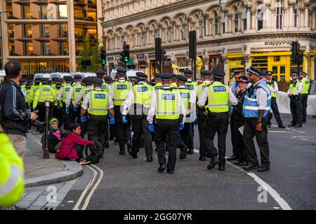 London, UK. 27th Aug, 2021. Police officers move in to arrest Extinction Rebellion's Impossible Rebellion protesters who blocked the road at Mansion House, London during their 'Blood Money March Decolonise the Economy' claiming the City of London was built on Blood Money. (Photo by Dave Rushen/SOPA Images/Sipa USA) Credit: Sipa USA/Alamy Live News Stock Photo