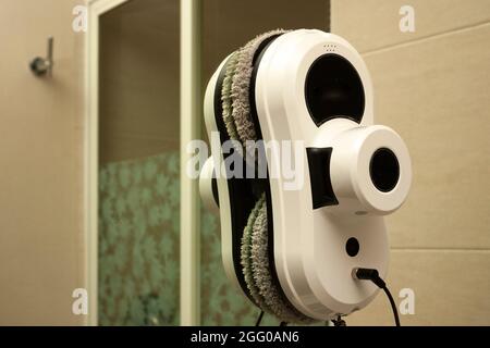 Automated robotics cleaning service for glassware working on glass and mirrors in home bathroom in Mexico city Stock Photo