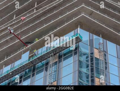 Workers inserting windows on a high-rise building, Frankfurt am Main, Germany Stock Photo