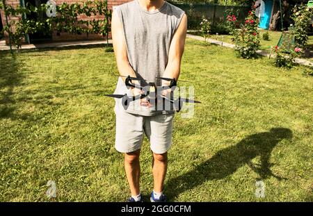 Modern small compact quadcopter in a man's hand. Launching a drone from your hand. Stock Photo