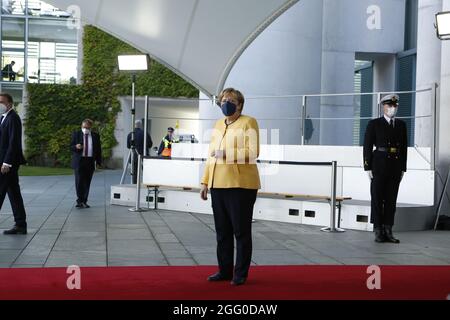 Berlin, Germany. 27th Aug, 2021. Berlin: Chancellor Angela Merkel receives the head of state . shortly before the conference on the “G20 Compact with Africa (CwA)” in the courtyard of the Federal Chancellery. (Photo by Simone Kuhlmey/Pacific Press) Credit: Pacific Press Media Production Corp./Alamy Live News Stock Photo