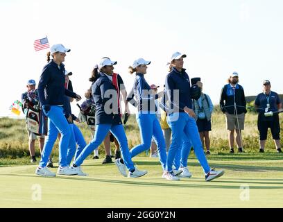 Team USA's Captain Sarah Ingram runs onto the 16th green to celebrate with Allisen Corpuz and  Rose Zhang after their 3&2 win during the 2021 Curtis C Stock Photo