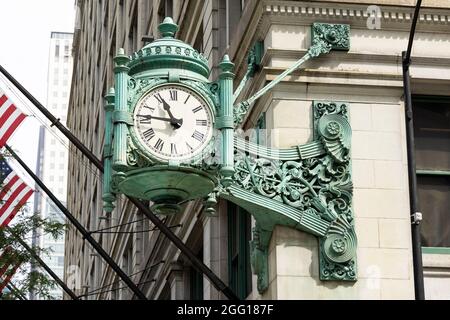 The clock on the Marshall Field building (now home to Macy's) on State Street in the Loop neighborhood of Chicago, Illinois, USA. Stock Photo