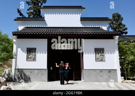 Los Angeles, USA. 28th Aug, 2021. Visitors are seen at the entrance of the Studio for Lodging the Mind in Los Angeles, the United States, Aug. 27, 2021. The Huntington Library, Art Museum and Botanical Gardens, will open to the public a new art gallery, the Studio for Lodging the Mind, or Yu Yi Zhai in Chinese, in its Chinese Garden with an exhibition of Chinese calligraphy as its inaugural installation on Aug. 28. Credit: Xinhua/Alamy Live News Stock Photo