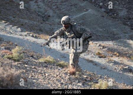 U.S. Army Spc. Mario Bedford of Vacaville, Calif., 2nd Platoon, Troop C, 1st Squadron, 61st Cavalry Regiment, Task Force Panther, negotiates the terrain during operations in Sherzad District, Nangarhar Province, Afghanistan, Dec. 27, 2010. (U.S. Army photo by Spc. Andy Barrera) Stock Photo