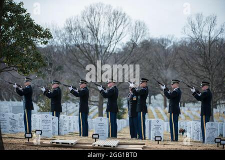 The U.S. Army Honor Guard firing party fires 3 folleys during the funeral of U.S. Army Sgt. 1st Class Mihail Golin in Section 60 of Arlington National Cemetery, Arlington, Virginia, Jan. 22, 2018. Golin, an 18B Special Forces Weapons Sergeant assigned to 10th Special Forces Group (Airborne) died Jan. 1, 2018, as a result of wounds sustained while engaged in combat operations in Nangarhar Province, Afghanistan.  Golin deployed to Afghanistan in September 2017 with the 2nd Battalion, 10th Special Forces Group, in support of Operation Freedom’s Sentinel.  Golin enlisted Jan. 5, 2005 and this was Stock Photo