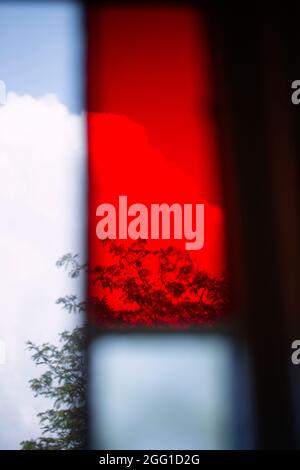 Sky and trees through a stained glass window Stock Photo