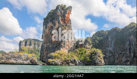 Rugged cliffline between Ao Nang Beach and Railay beach in Krabi Thailand. This beautiful area is a popular destination in Thailand Andaman Sea Stock Photo