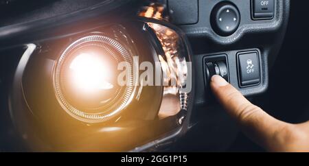 Driver hand adjusting headlight level switch and car headlight bright,Double exposure automotive concept Stock Photo