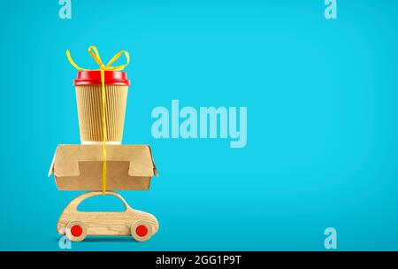 Retro toy car delivering fast food order on blue background. Copy space Stock Photo