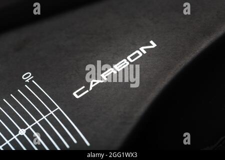 Composite product made of carbon fiber with the inscription CARBON and a distance scale. Macro, close-up Stock Photo