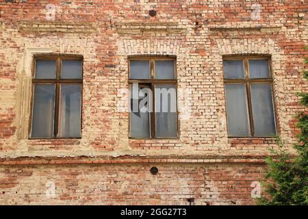 Broken windows in an old brick facade in Görlitz Stock Photo