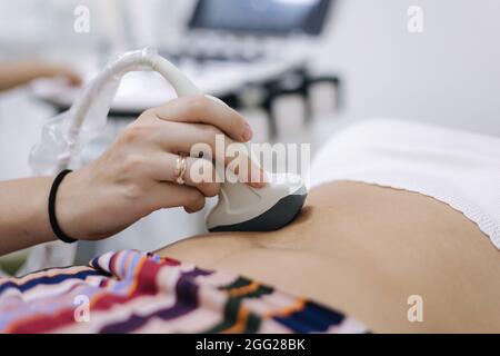 Male doctor performing ultrasound on patient. Close-up Stock Photo