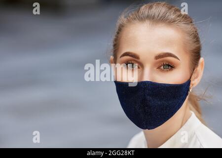 business woman in protective medical mask outdoors Stock Photo