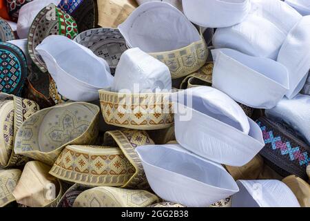 A pile of various designed taqiyah cap or muslim prayer cap Stock Photo