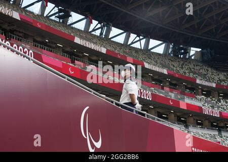 Tokio, Japan. 28th Aug, 2021. Paralympics: Athletics, at the Olympic Stadium. Security personnel look in the direction of the empty spectator stands. Credit: Marcus Brandt/dpa/Alamy Live News Stock Photo