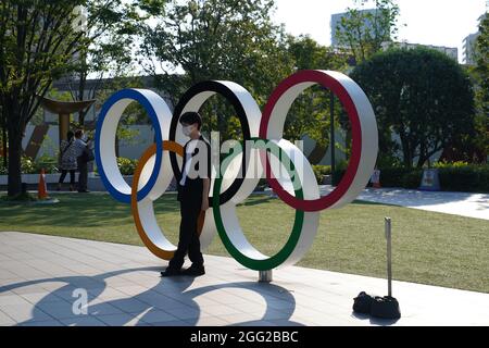 Tokio, Japan. 28th Aug, 2021. Paralympics: Athletics, at the Olympic Stadium. A man has his picture taken in front of the Olympic rings. Credit: Marcus Brandt/dpa/Alamy Live News Stock Photo