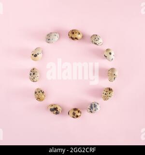 Easter background. Circle of eggs on pastel pink layout. Minimal holiday concept. Stock Photo