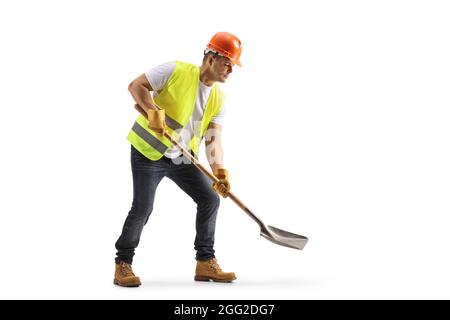 Construction worker with a vest and hardhat using a shovel isolated on white background Stock Photo