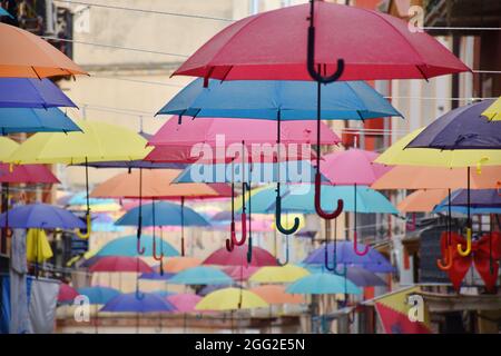 Colorful umbrellas on the street in Iglesias, Sardinia, Italy Stock Photo