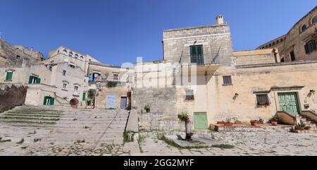 Matera, Italy - August 17, 2020: View of the Sassi di Matera a historic district in the city of Matera, well-known for their ancient cave dwellings. B