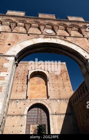 Porta Ovile, Imposing city gate from the 13th century with a curved arch and battlements, Siena, Tuscany, Italy Stock Photo