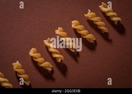 whole meal Fusilli pasta on dark background. top view ,healthy eating , Stock Photo