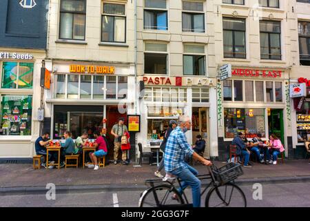 Amsterdam, Holland, Street Scenes, Row of Shops, Tourists Sharing Meals on Terrace of Fast Food Restaurants Stock Photo