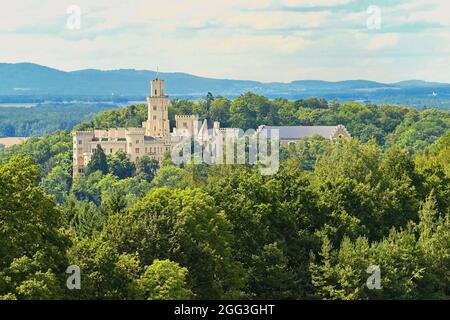 Beautiful old state chateau Hluboká nad Vltavou. View from the outdoor garden in summer with blue sky, sun and clouds. Stock Photo