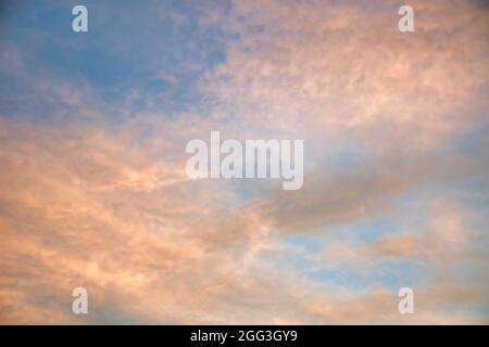 Beautiful sky painted by the sun leaving bright golden shades.Dense clouds in twilight sky in a summer evening.Image of cloud sky on evening time.Even Stock Photo