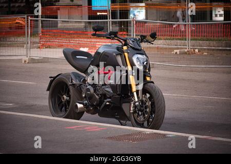 Milan, Italy 08.27.2021 A black Ducati Diavel 1260 The biggest classic motorcycle in front of Sforza Castle Stock Photo