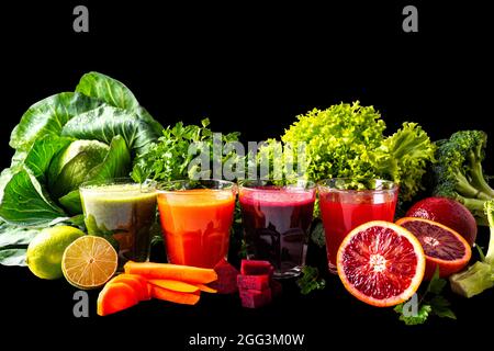 Vegan drinks with fruits and vegetables on the black isolated background Stock Photo