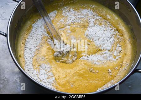 Close-up of a bowl in which the mixture of the necessary ingredients to make a carrot cake is being made Stock Photo