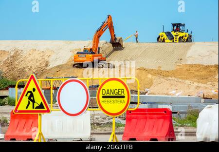 Dnepropetrovsk, Ukraine - 08.17.2021:Road sign No traffic, construction work and danger. The word danger is written in Ukrainian. Signs on the backgro Stock Photo