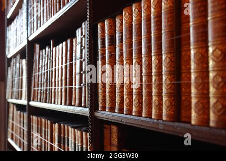 Old books in a bookcase Stock Photo