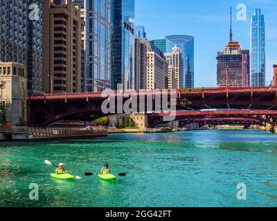 Two women kayaking the Chicago river near the State Street Bridge. Chicago, Illinois Stock Photo