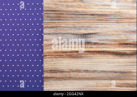 Purple polka dot tablecloth on wooden table. Top view background Stock Photo