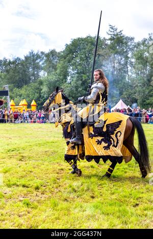 8th August 2021 - Knight on horseback holding lance during jousting tournament at Medieval festival Loxwood Joust, West Sussex, England, UK Stock Photo