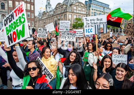 Amsterdam, Netherlands. 28th Aug, 2021. Protesters hold placards during the demonstration.Thousands of people gathered in the center of Amsterdam to show their support for the Afghanistan people trapped in Kabul under the Taliban regime and to urge the Dutch Government to declare Afghanistan an unsafe country of origin so Afghan refugees and Afghan undocumented people can have the legal right to asylum and safety. (Photo by Ana Fernandez/SOPA Images/Sipa USA) Credit: Sipa USA/Alamy Live News Stock Photo