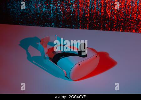 Virtual reality helmet on white background in neon light. VR, future, gadgets, technology concept. Stock Photo