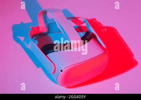 Virtual reality helmet on white background in neon light. VR, future, gadgets, technology concept. Stock Photo