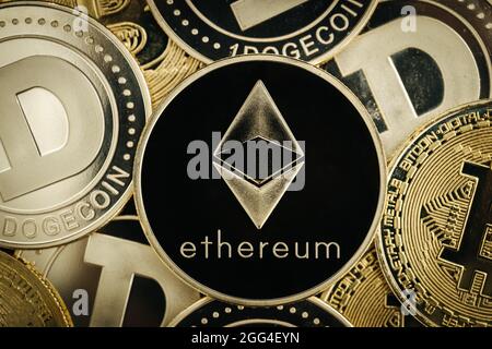Ethereum cryptocurrency, physical coin close-up, on top of other cryptocurrency coins Stock Photo