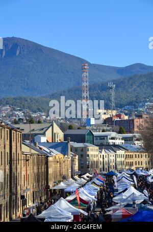 Sunny winter morning at Salamanca Market in Hobart with art and craft stalls and fresh produce with Mount Wellington in the background Stock Photo