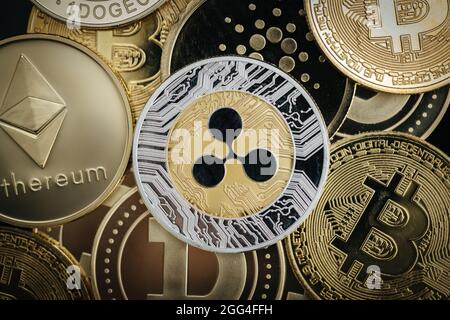 Ripple XRP cryptocurrency, physical coin close-up, on top of other cryptocurrency coins Stock Photo