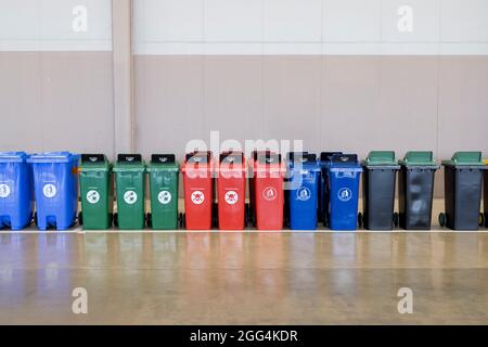 A row of multi colors industrial plastic garbage containers. Stock Photo