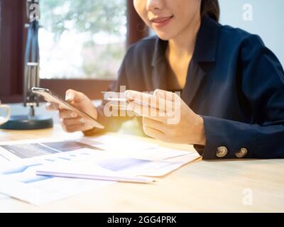 Businesswoman ceo manager company office is pointing finger touchscreen hand tablet  smartphone computer notebook laptop work job career.Female is sho Stock Photo