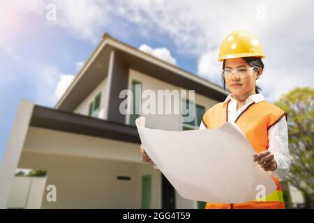 Engineer or architect with blueprint for house building Stock Photo