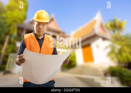Engineer or architect with blueprint for house building Stock Photo
