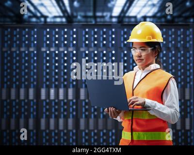 Programmer or engineer with computer notebook in server room Stock Photo