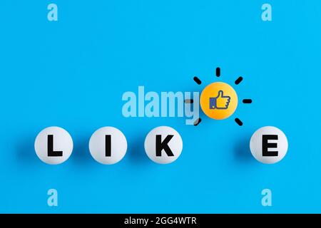 Like icon and the word like written on table tennis balls. Social media interaction, likeability or like us on internet concept. Stock Photo